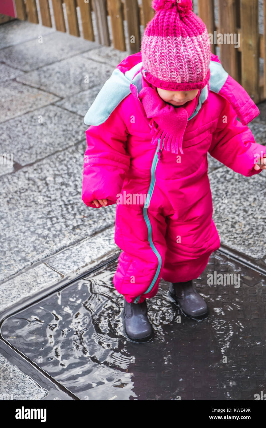 baby girl puddle pink winter clothes boots female Stock Photo - Alamy