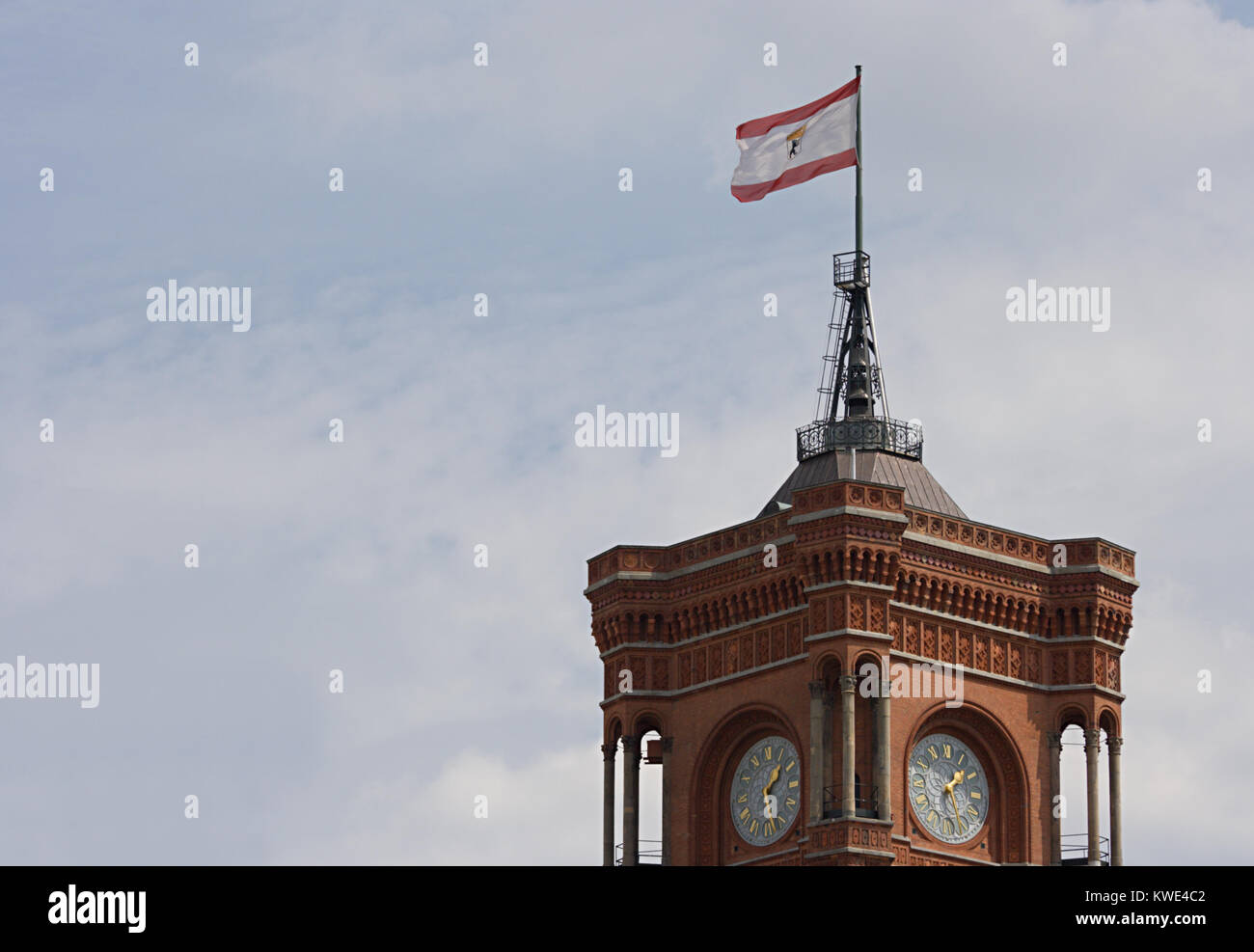 Tower of the red town hall in Berlin, on top the Berlin flag. Stock Photo