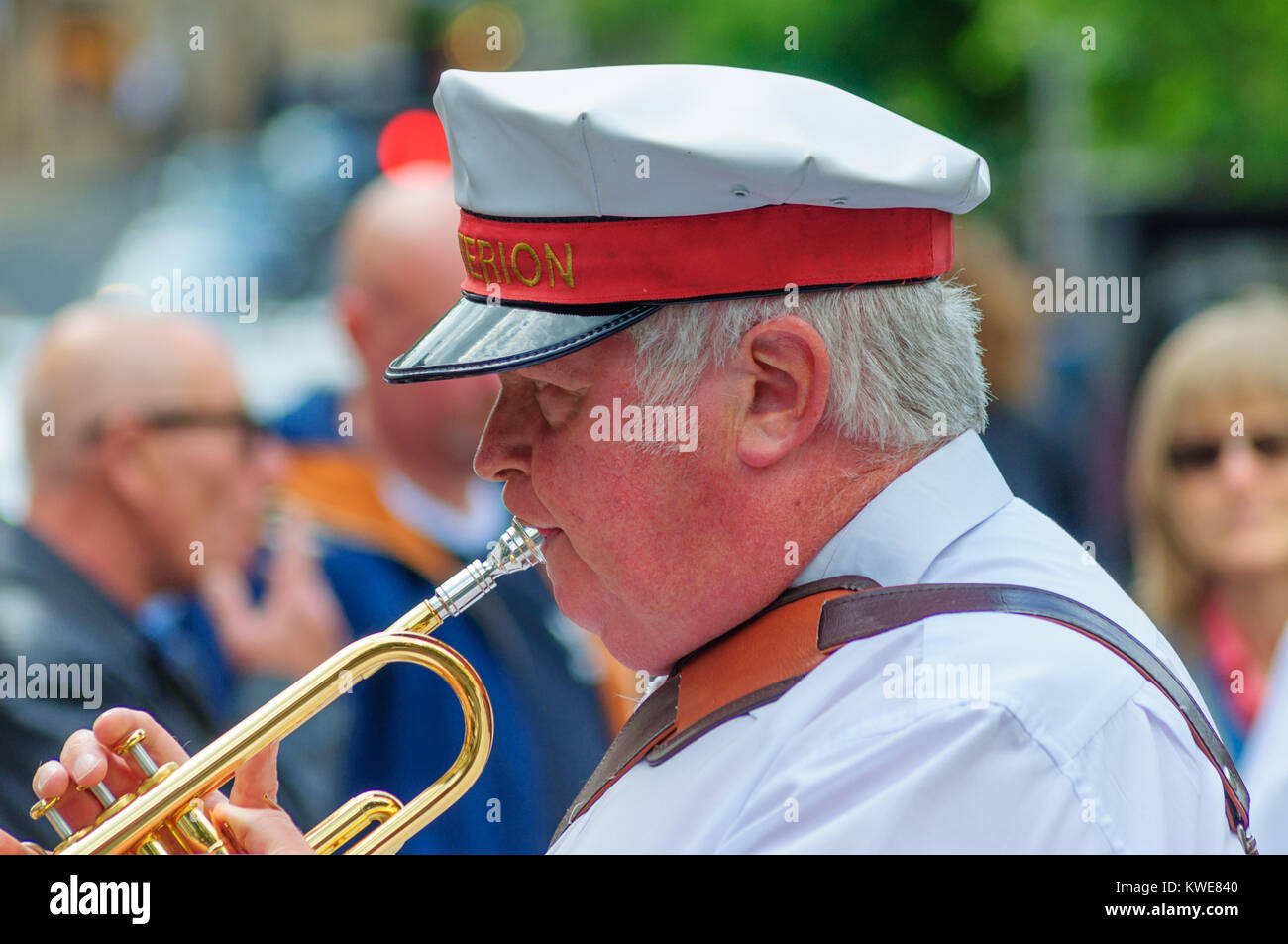 Male musician from the Criterion Brass Band playing a trumpet in the