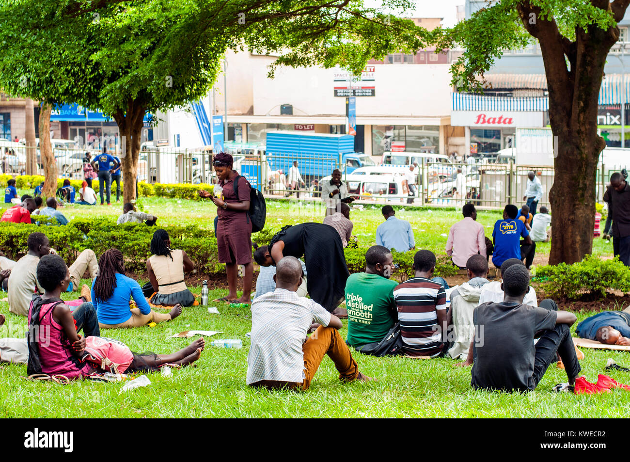People relaxing in Constitution Square Gardens, Kampala, Uganda Stock Photo
