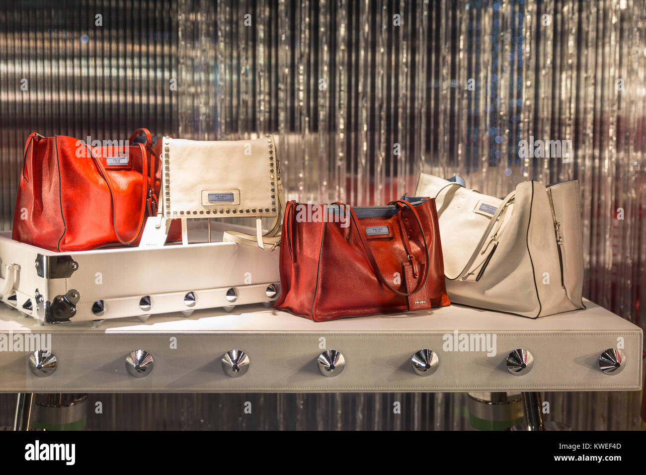 Prada luxury handbags, totes and desginer label luggage on display in a Prada store shop window in Cannes, Cote d'Azur, France Stock Photo