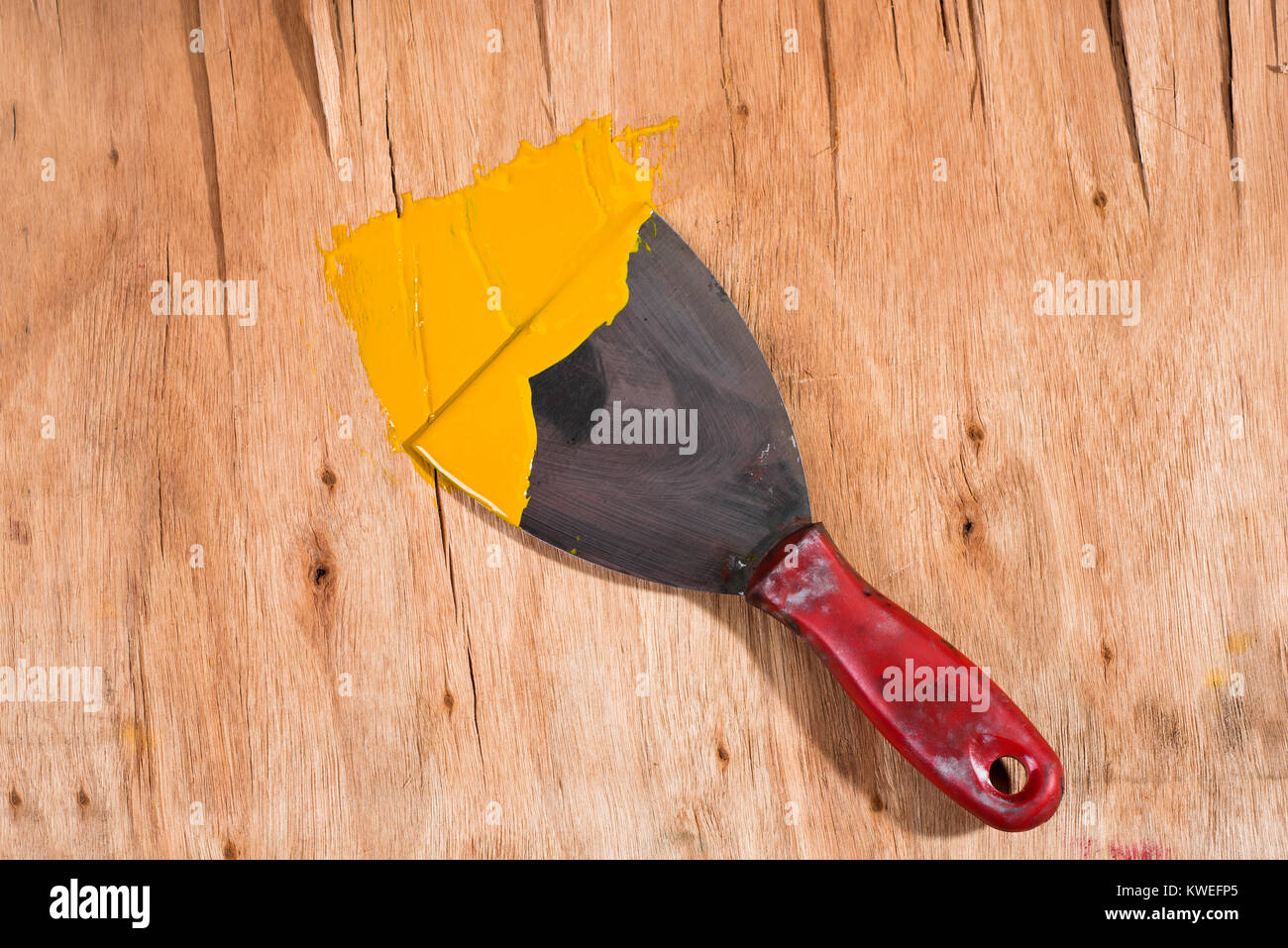 yellow paint on spatula Stock Photo