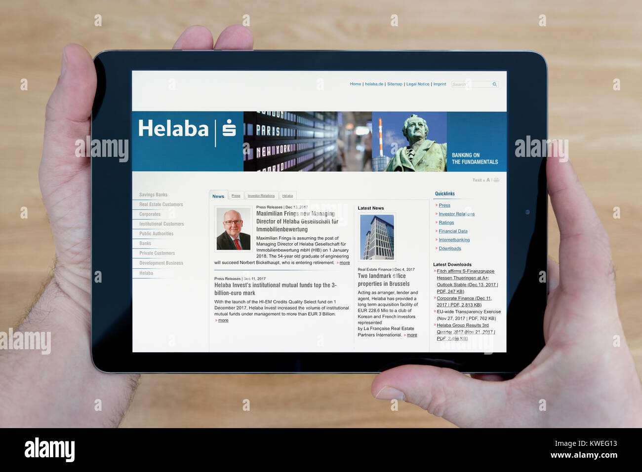 A Man Looks At The Helaba Bank Website On His Ipad Tablet Device