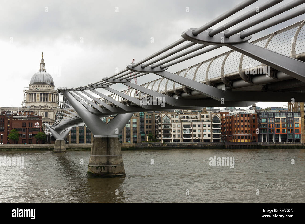 St. Paul's Cathedral and Wobbly Millenium Bridge in London on an overcast spring day. Stock Photo