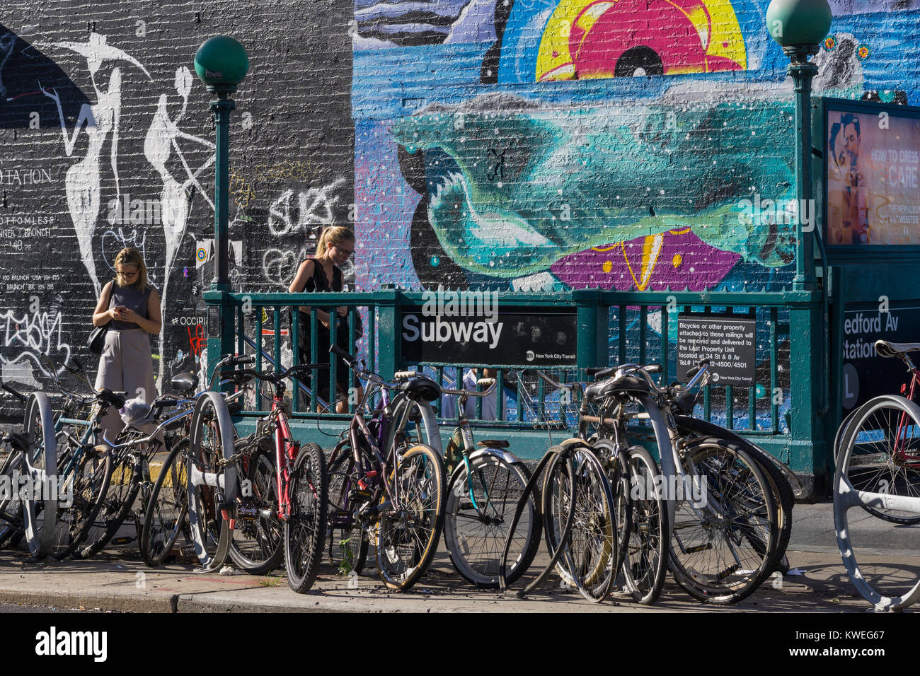 Street art and bicycles near the Bedford Avenue subway station. Early summer morning in Williamsburg, New York City. Stock Photo