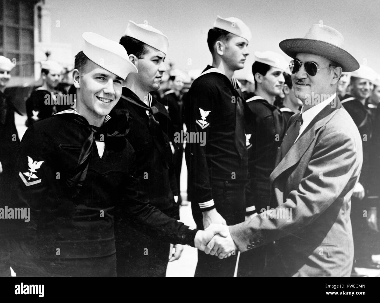Igor Sikorsky (1889 - 1972) developer of the first successful helicopter, shakes hands with his son, Sergei, who is training at a US Coast Guard Air Station near New York City, on 22nd November 1944. The Russian born inventor was attending a demonstration of the use of the Sikorsky Helicopter for air-sea rescue operations. Stock Photo