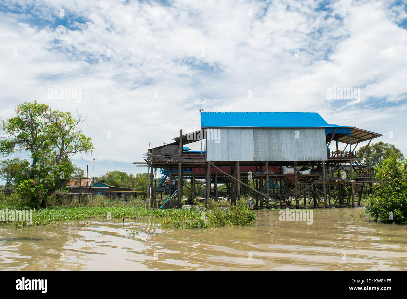 Houses in Kampong Phluk floating village, suspended on stilts over water of Tonle Sap Great Lake floodplain, near Siem Reap, Cambodia, South East Asia Stock Photo
