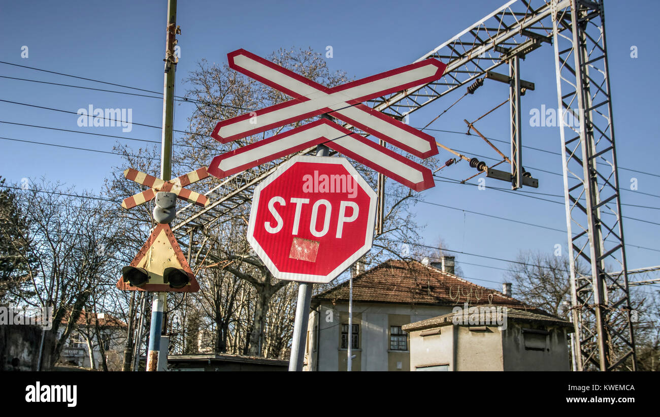 Serbia - Traffic signs on the road in front of a railroad crossing intersection Stock Photo