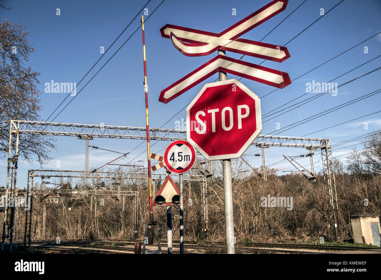 Serbia - Traffic signs on the road in front of a railroad crossing intersection Stock Photo