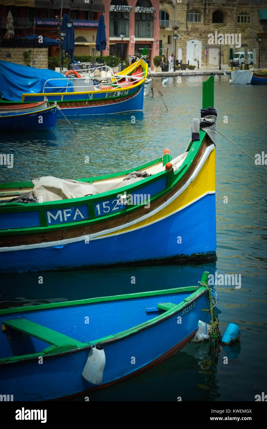 Traditional Maltese brightly coloured luzzu fishing boats in St Julian's Bay, Malta, Mediterranean Sea, Europe Stock Photo