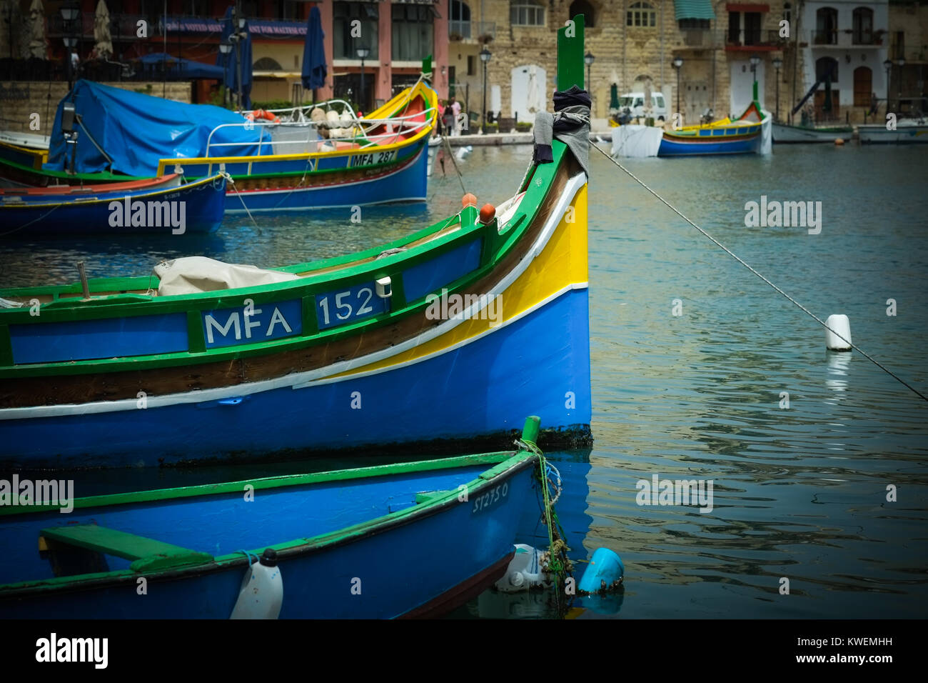 Traditional Maltese brightly coloured luzzu fishing boats in St Julian's Bay, Malta, Mediterranean Sea, Europe Stock Photo