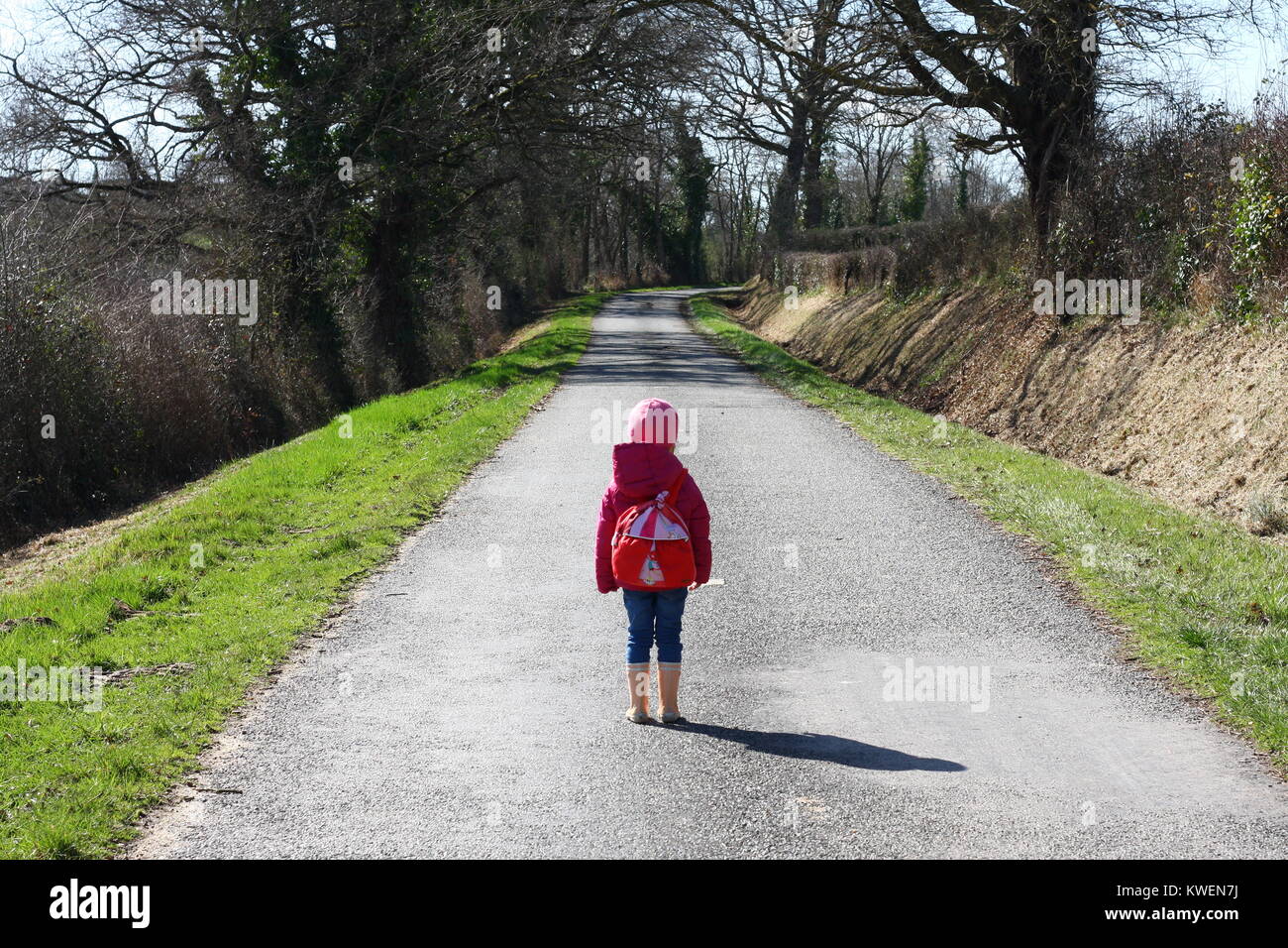 a girl with a backpack on the road Stock Photo - Alamy