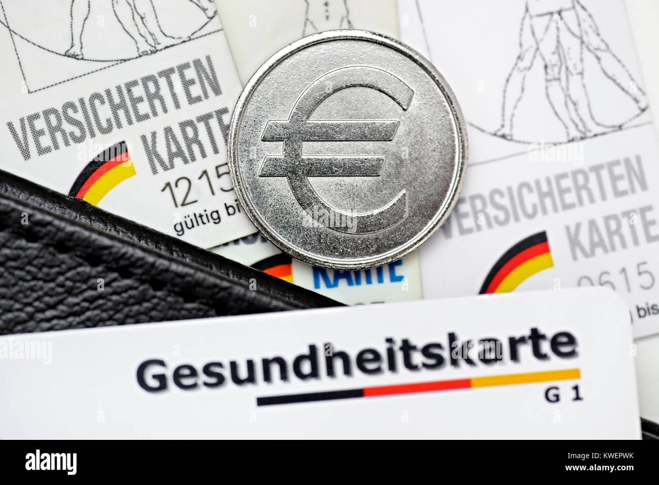 Insured maps and eurocoin, health insurance scheme contributions, Versichertenkarten und Eurom?nze, Krankenkassenbeitr?ge, Versichertenkarten und Euro Stock Photo