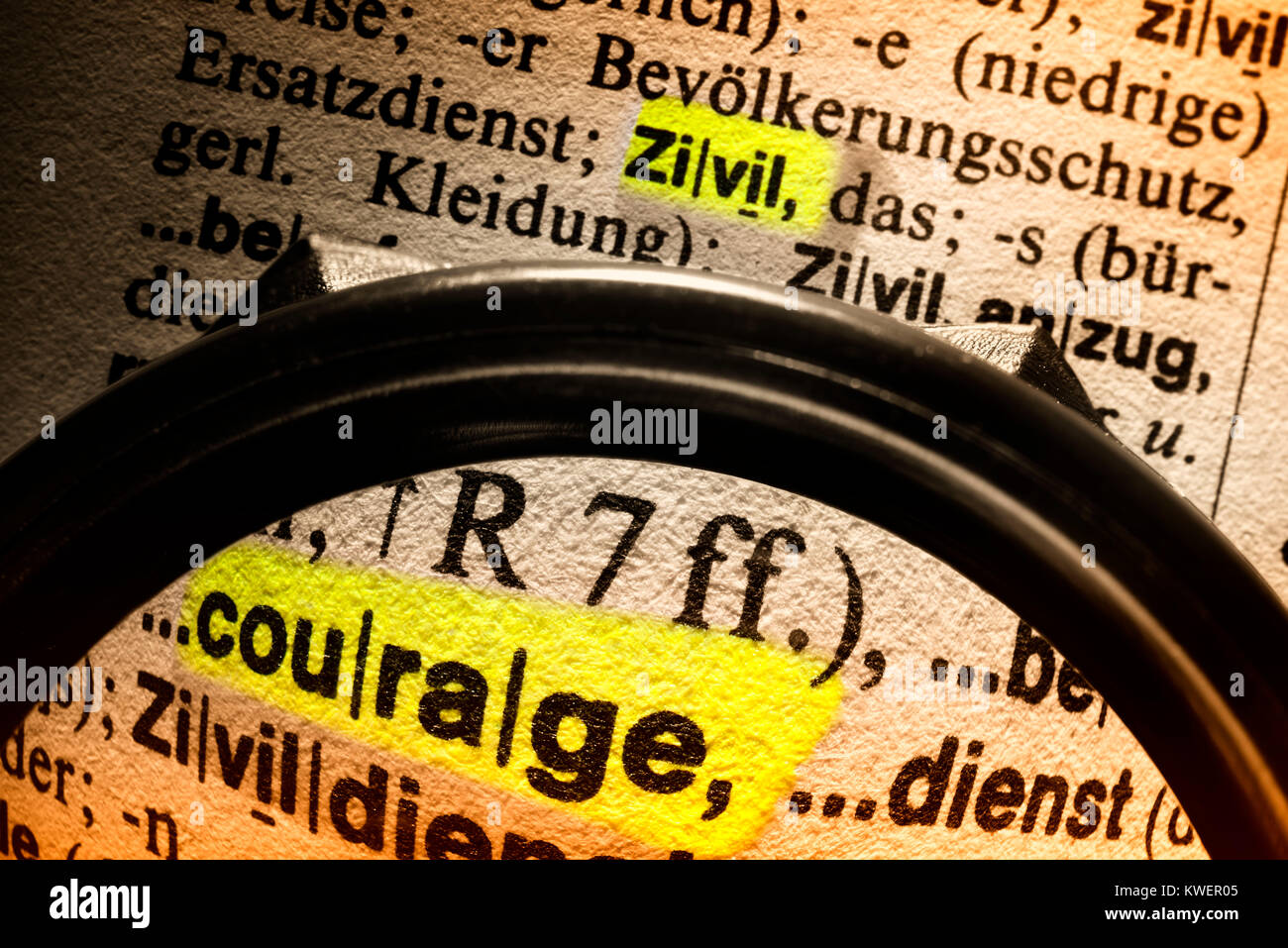The word Courage of the convictions in a dictionary under the magnifying glass, Das Wort Zivilcourage in einem W?rterbuch unter der Lupe, Das Wort Ziv Stock Photo
