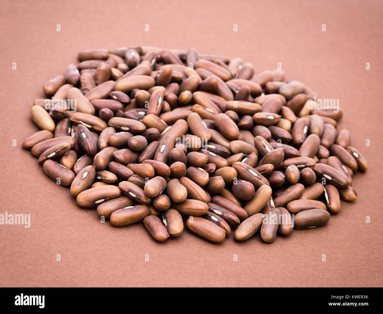Raw kidney beans on brown background, dutch angle view Stock Photo
