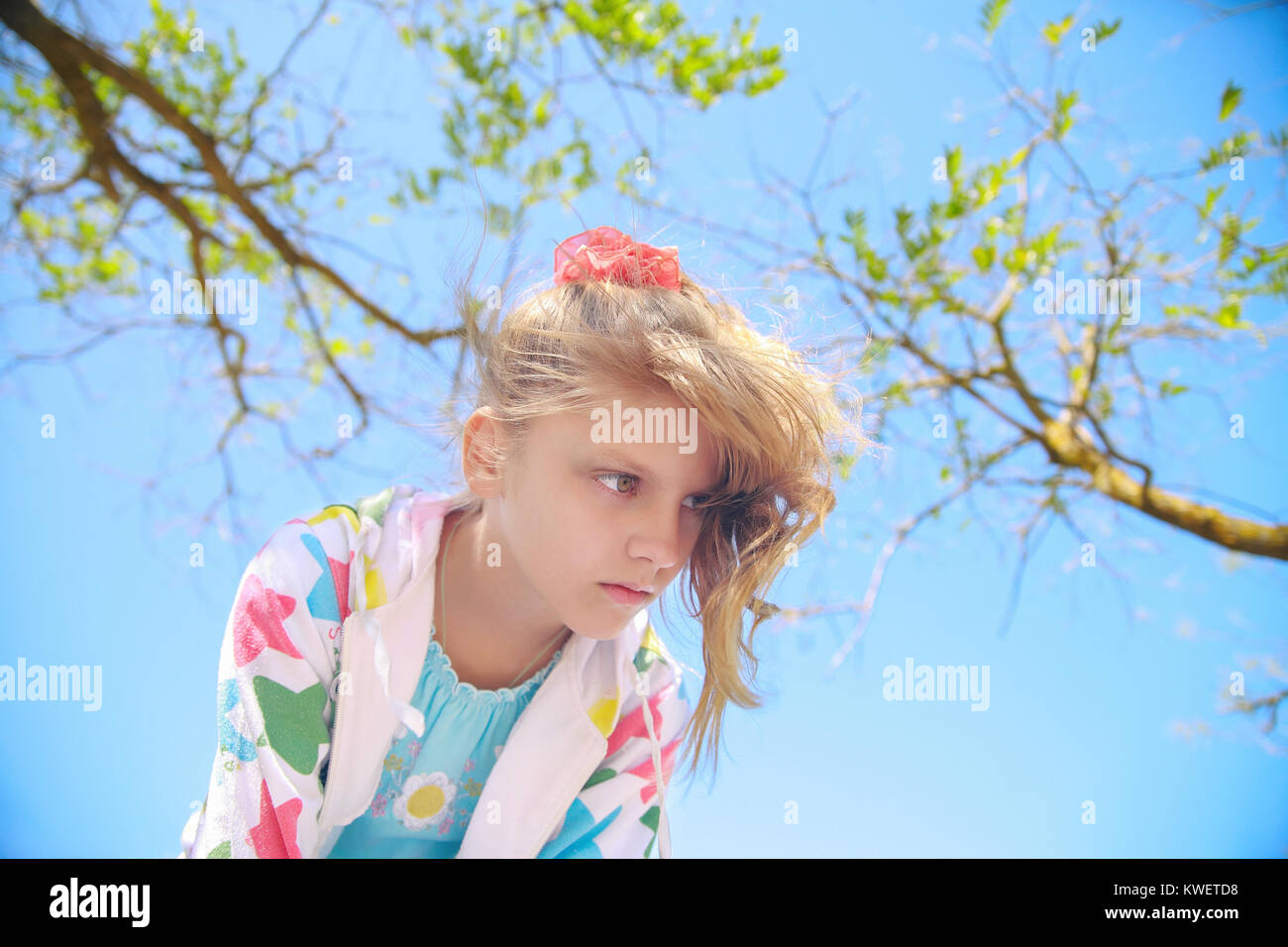 Little girl in the nature against the sky and trees Stock Photo - Alamy