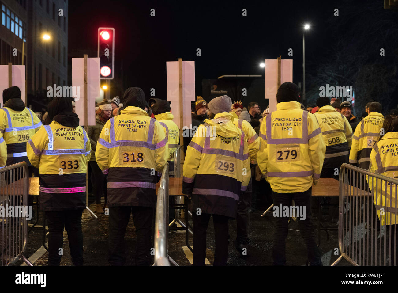 Security team minutes before gates are opened at  Edinburgh Hogmanay street party in the city on New Year's Eve. Scotland, United Kingdom. Stock Photo