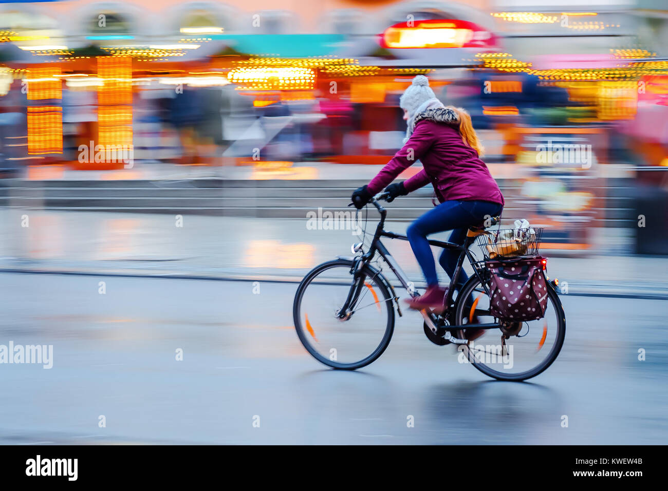 picture with camera made motion blur of a woman who rides a bicycle in ...