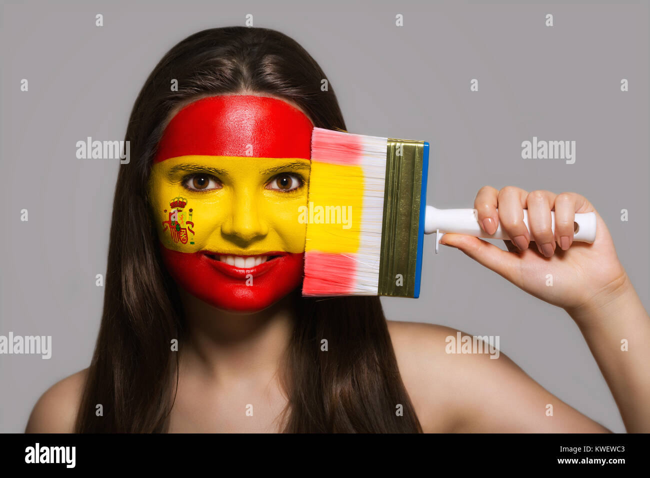 The face of a woman in the national colors of Spain Stock Photo