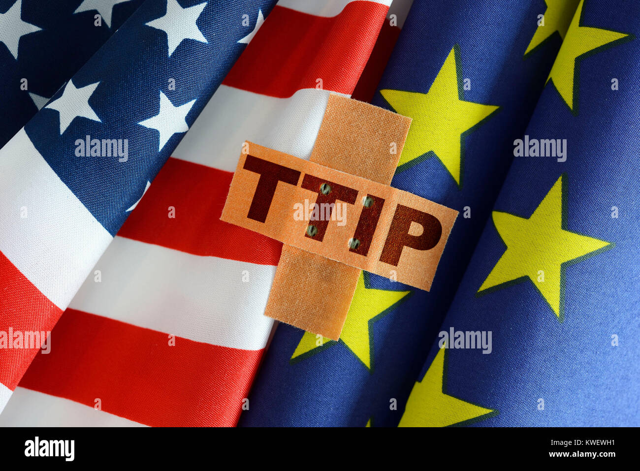 Flags of the USA and the EU with plaster and TTIP stroke, Fahnen von USA und EU mit Pflaster und TTIP-Schriftzug Stock Photo