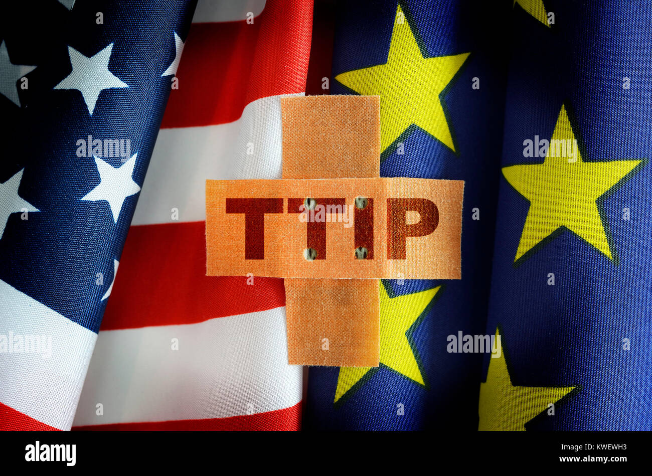 Flags of the USA and the EU with plaster and TTIP stroke, Fahnen von USA und EU mit Pflaster und TTIP-Schriftzug Stock Photo