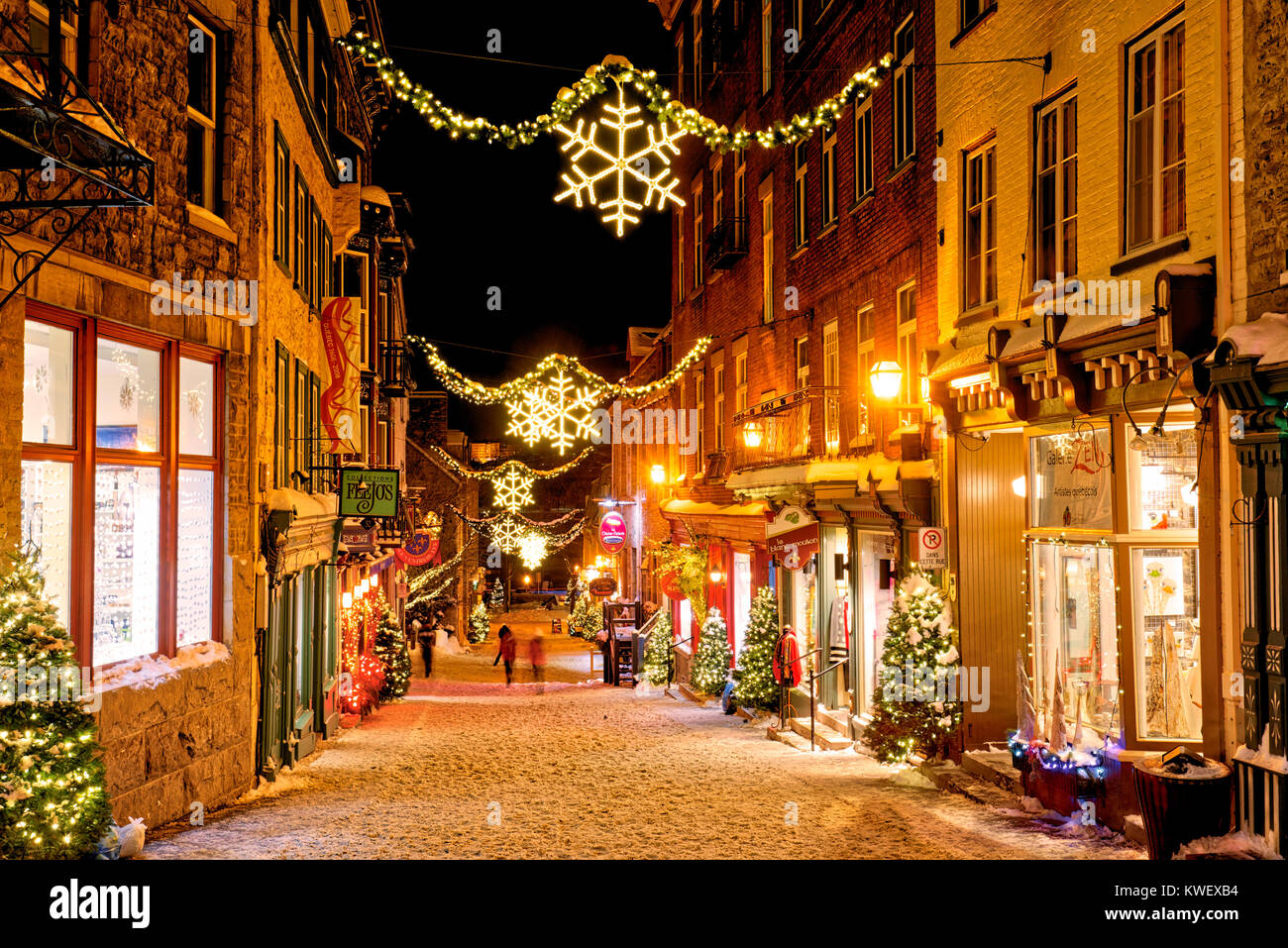 Christmas decorations and fresh snow in Quebec City's Petit Champlain area at night in Rue Sous -le-Fort Stock Photo