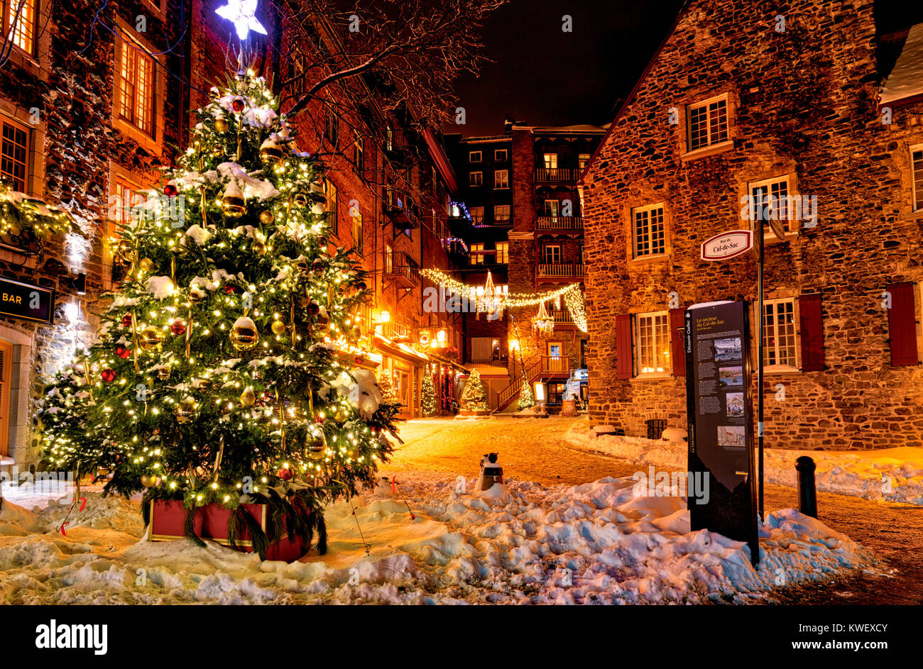 Christmas decorations and fresh snow in Quebec City's Petit Champlain area at night - in the Rue de Cul-de-Sac Stock Photo