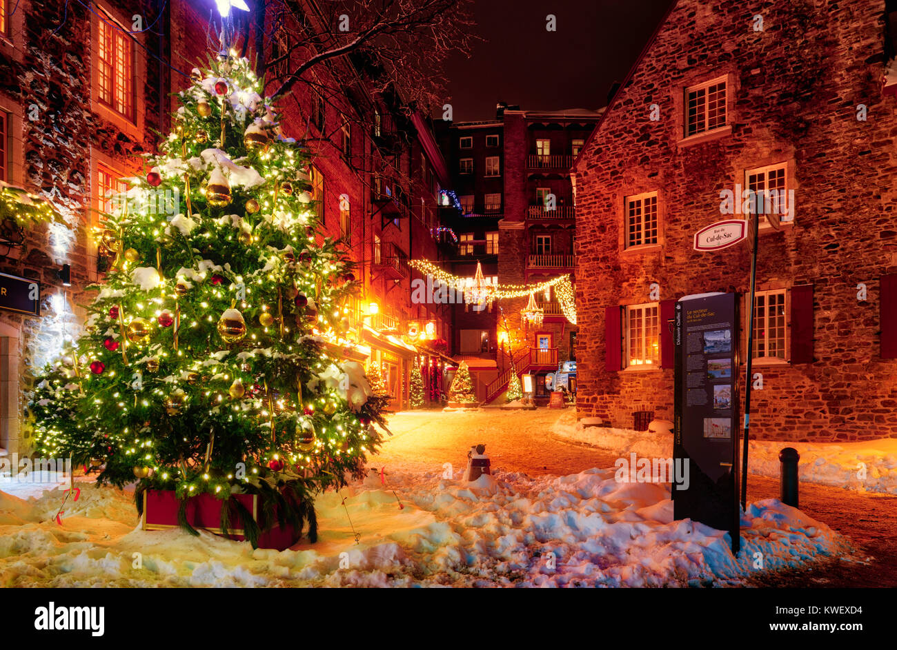 Christmas decorations and fresh snow in Quebec City's Petit Champlain area at night - in the Rue de Cul-de-Sac Stock Photo