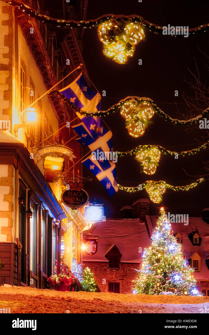 Christmas decorations and fresh snow in Quebec City's Petit Champlain area at night- looking along Rue Notre Dame to the christmas tree in Place Royal Stock Photo
