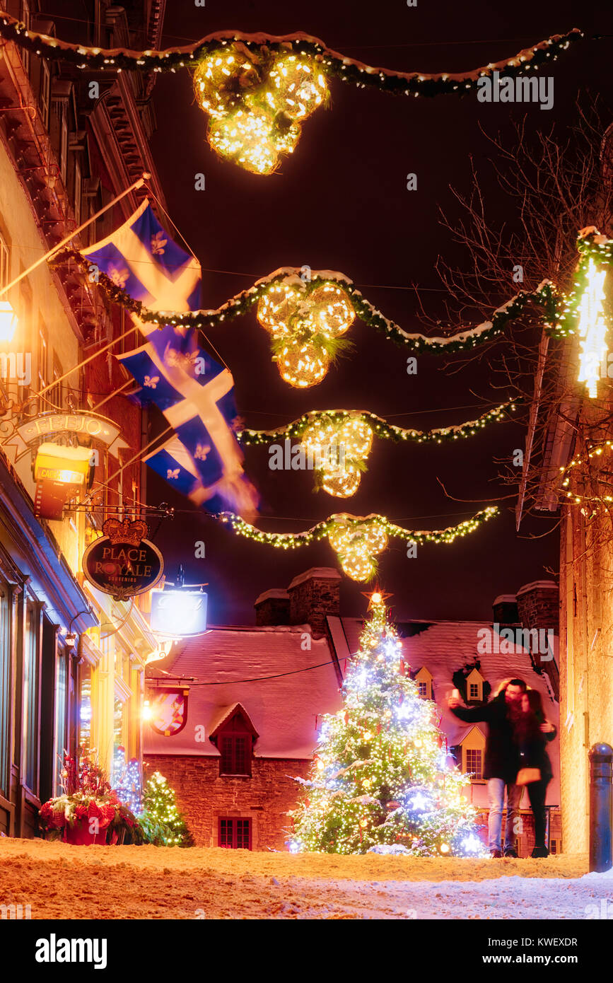 Christmas decorations and fresh snow in Quebec City's Petit Champlain area at night- along Rue Notre Dame to the christmas tree in Place Royale, with  Stock Photo