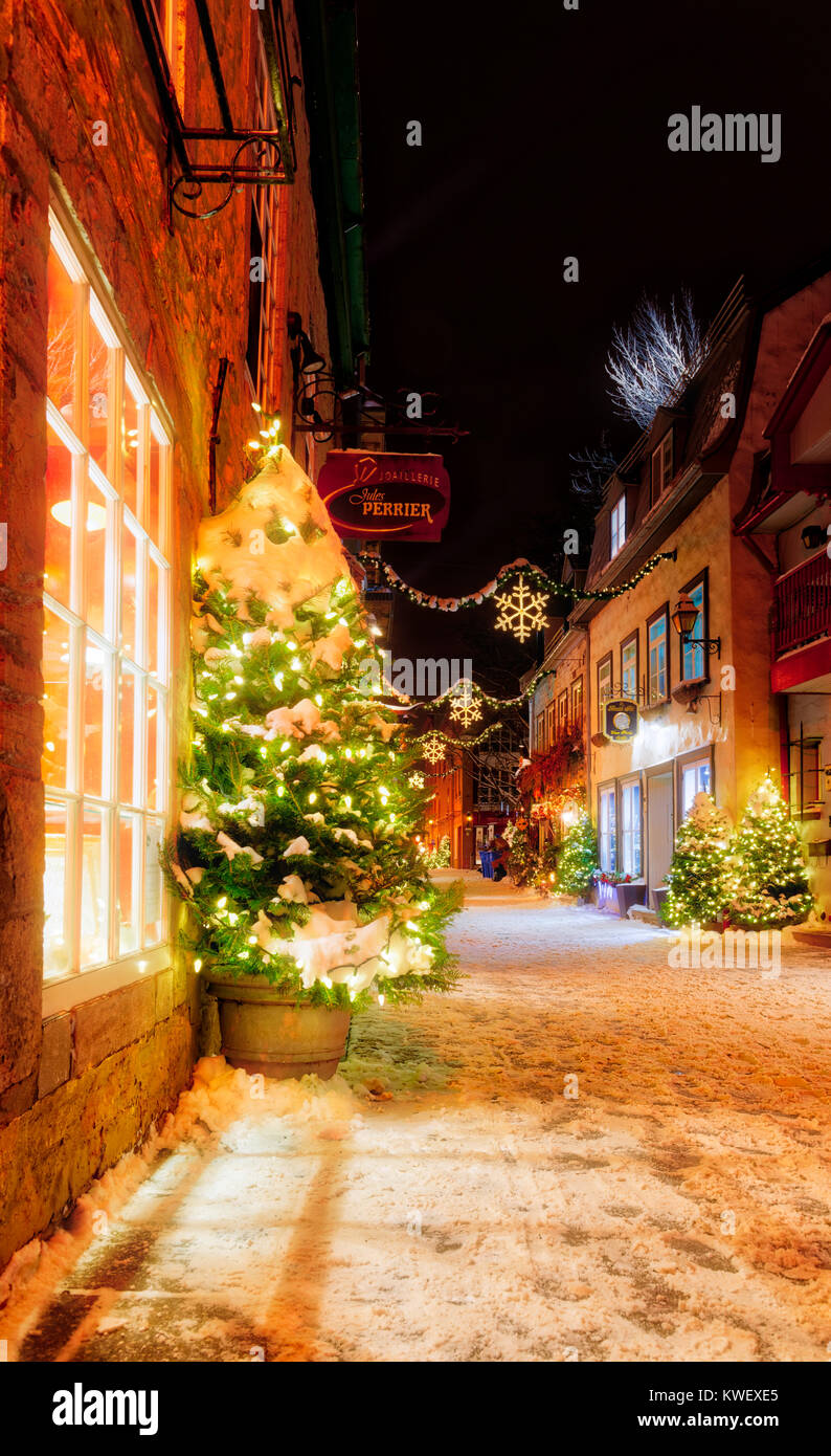 Christmas decorations and fresh snow in Quebec City's Petit Champlain area at night - in Rue Petit Champlain Stock Photo