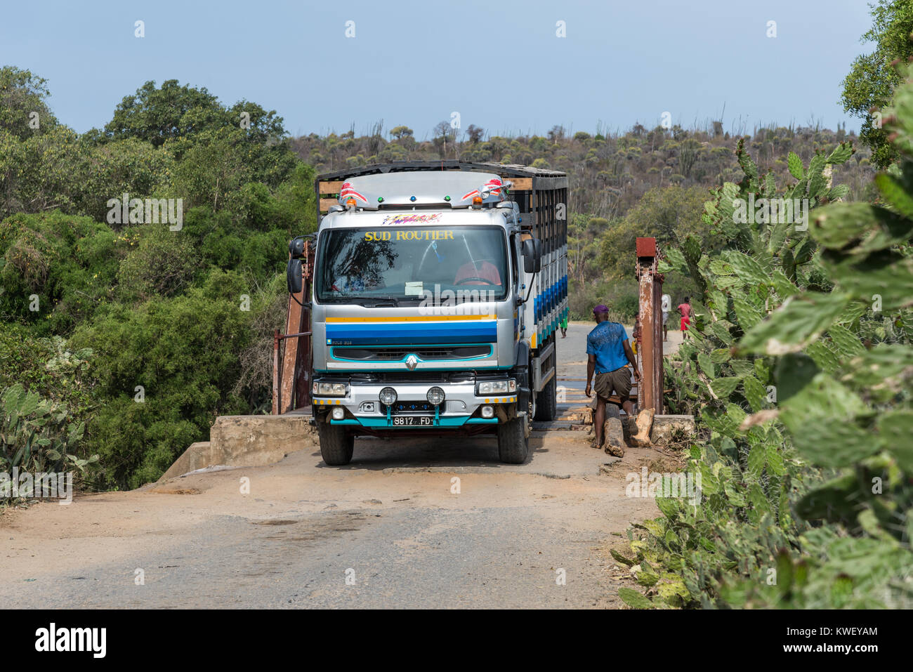 A heavy truck carefully driving across an old iron bridge. Madagascar, Africa. Stock Photo
