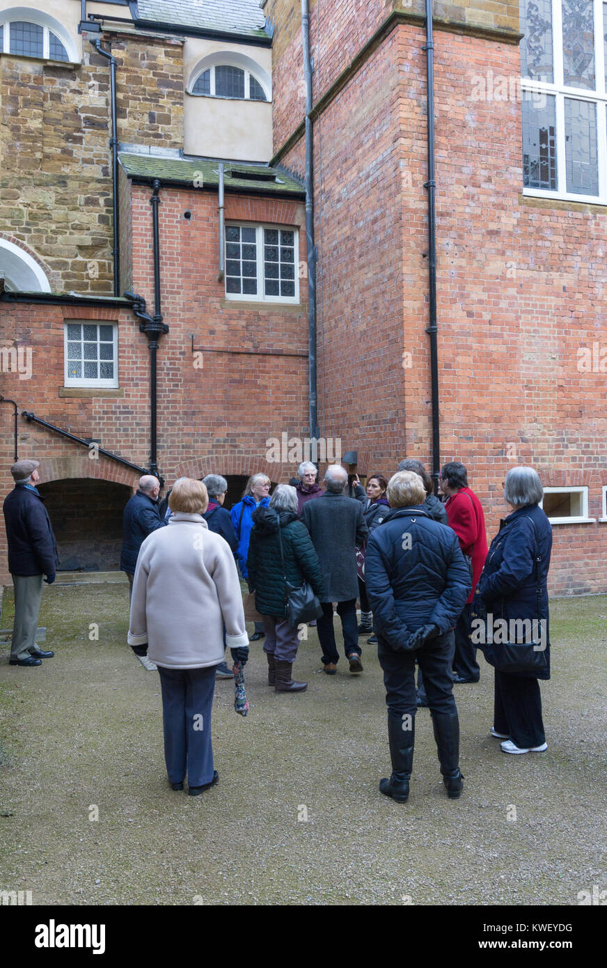 Group of seniors, members of a 50+ organisation, enjoying a guided tour of the newly restored Delapre Abbey, Northampton, UK Stock Photo