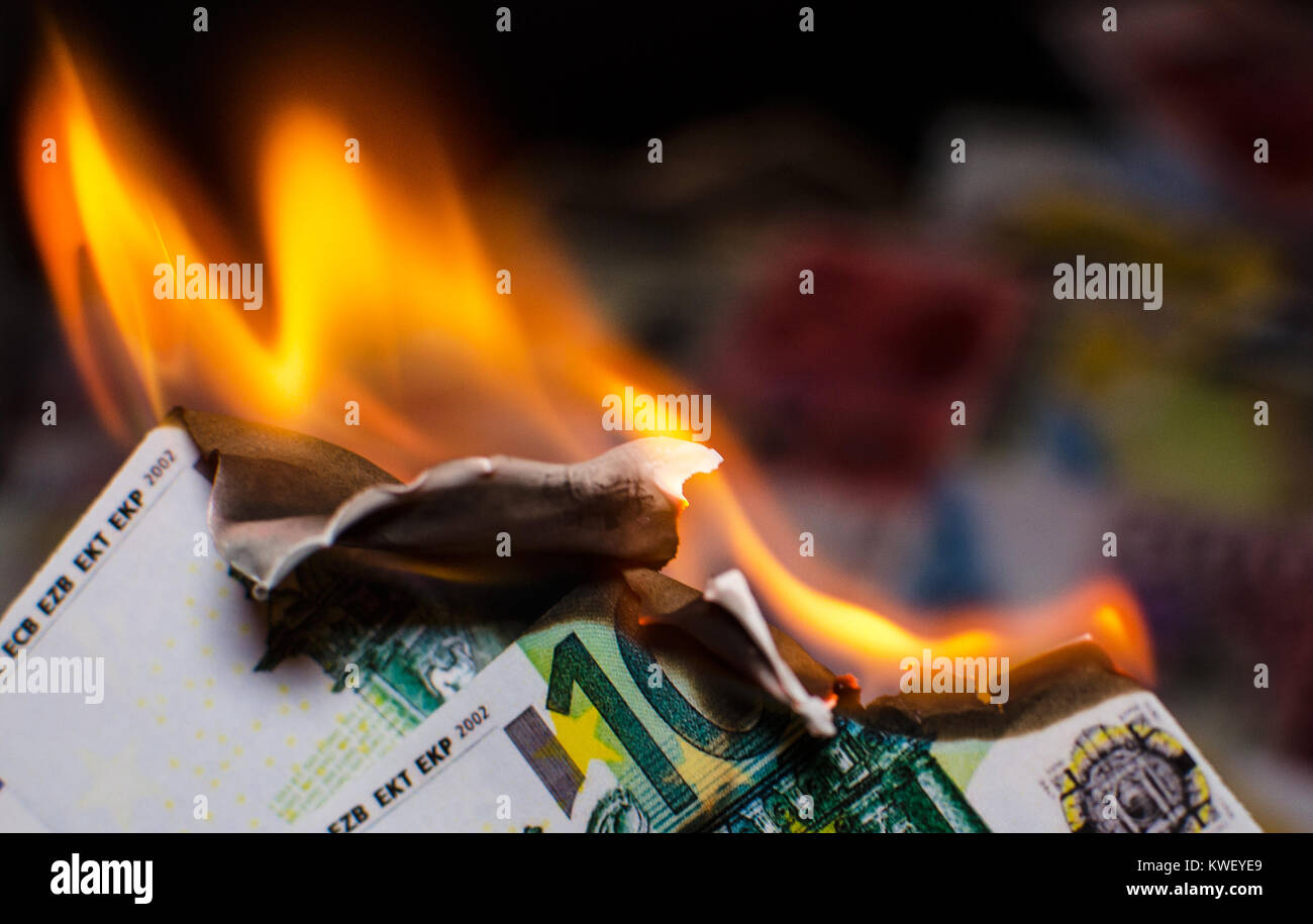 A hundred euro bill in Europe currency is on fire Stock Photo