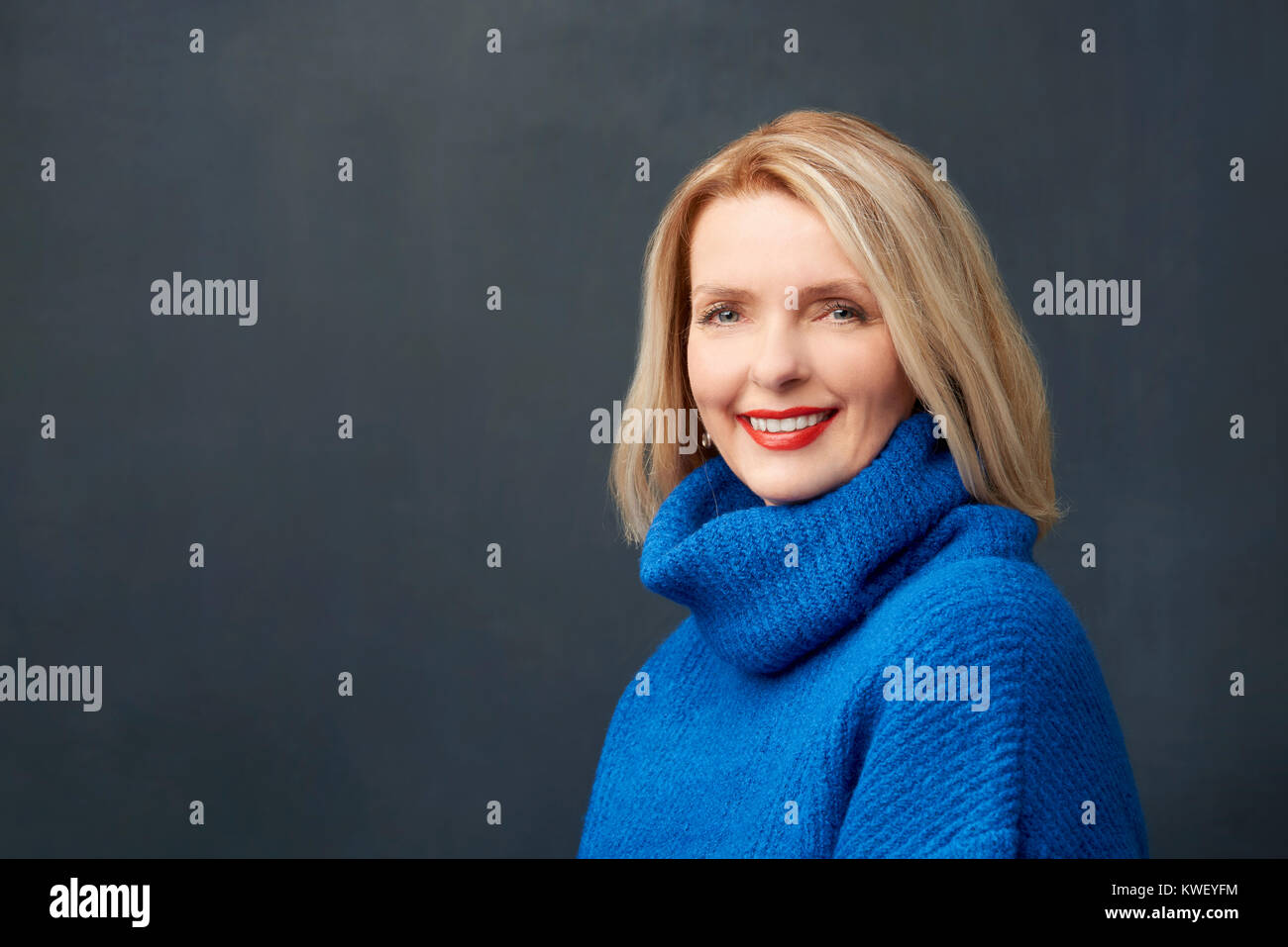 Close-up portrait shot of a beautiful mature woman looking at camera ...