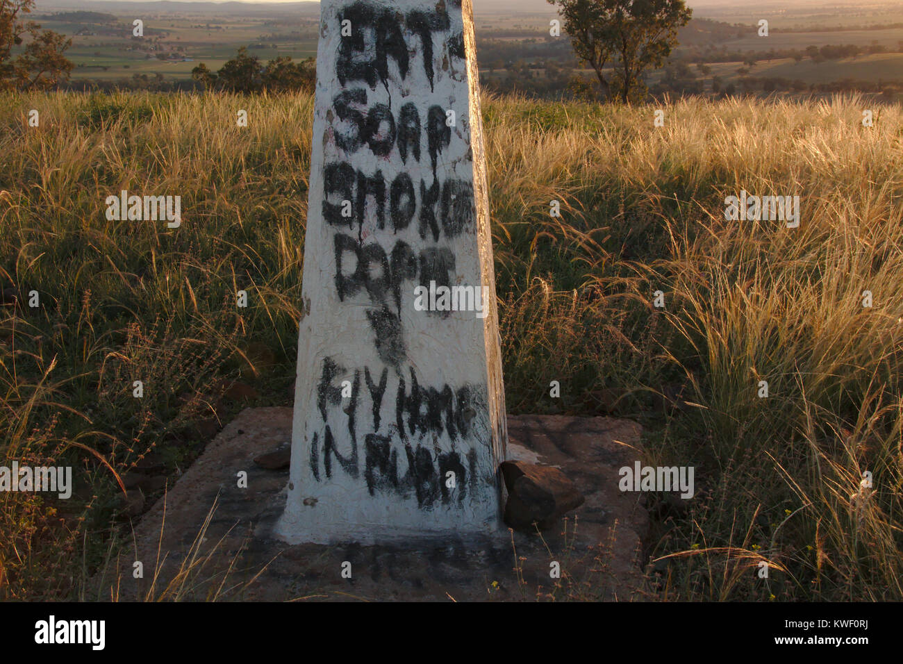 Eat soap smoke dope and fly home in a bubble - Graffiti on Trig point on  Bald Hill NSW Stock Photo - Alamy