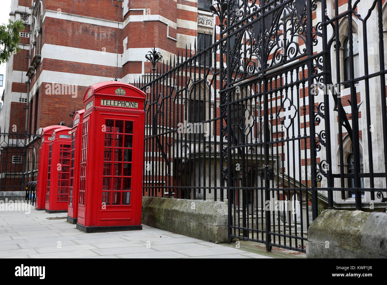 Classic old red telephone boxes pictured on a street in London, UK. Stock Photo
