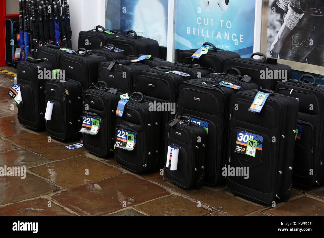 Suitcases for sale outside a Sports Direct Shop in Chichester High Street, UK. Stock Photo