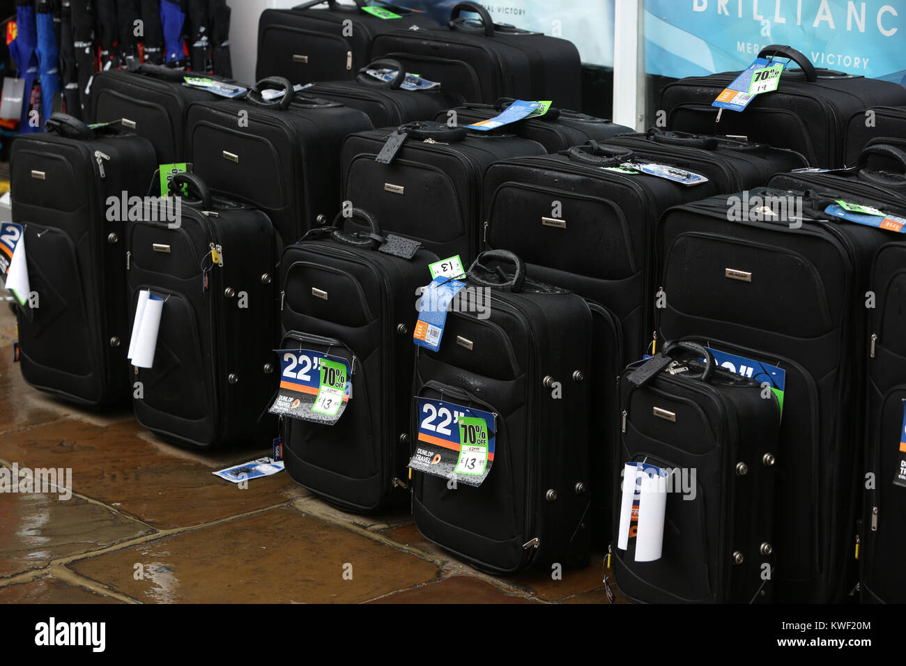 Suitcases for sale outside a Sports Direct Shop in Chichester High Street, UK. Stock Photo