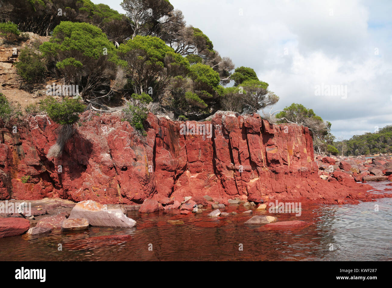 Red rock cliffs at Bittangabee Bay in Ben Boyd National Park, Eden, New South Wales, Australia. Travel photography, regional Australia. Stock Photo