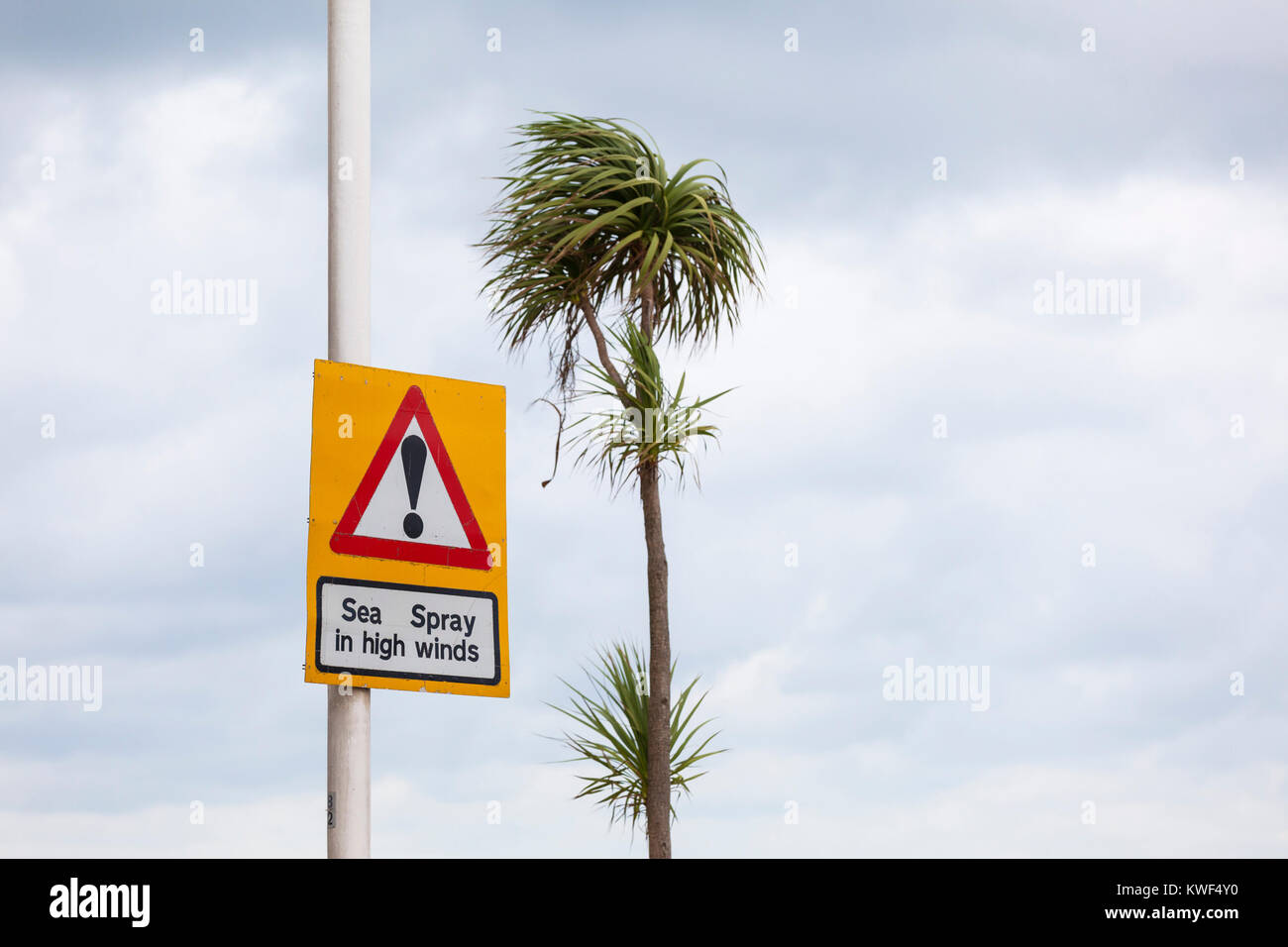 Sea spray in high winds signpost, windy weather sign, hastings, east sussex, uk Stock Photo