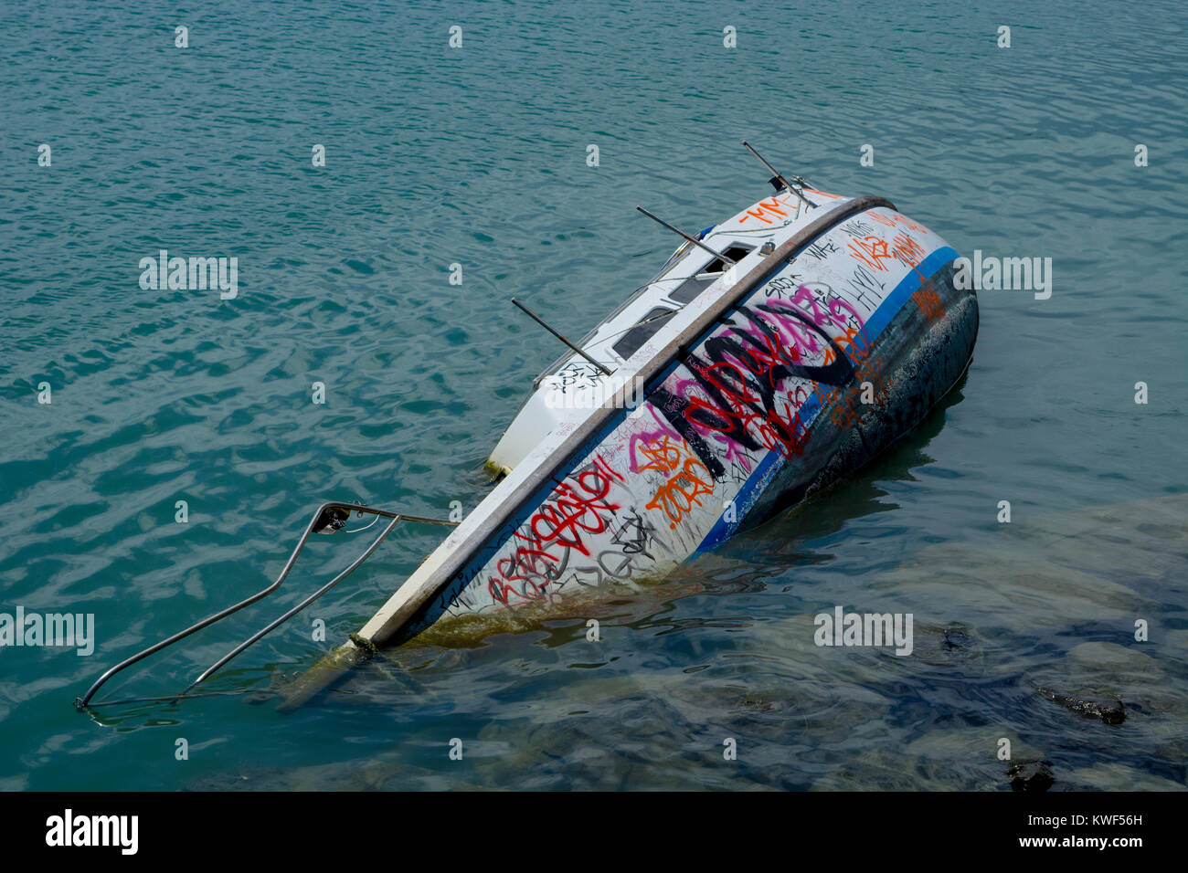 Yacht damaged by cyclone, abandoned and now a target for graffiti. Stock Photo