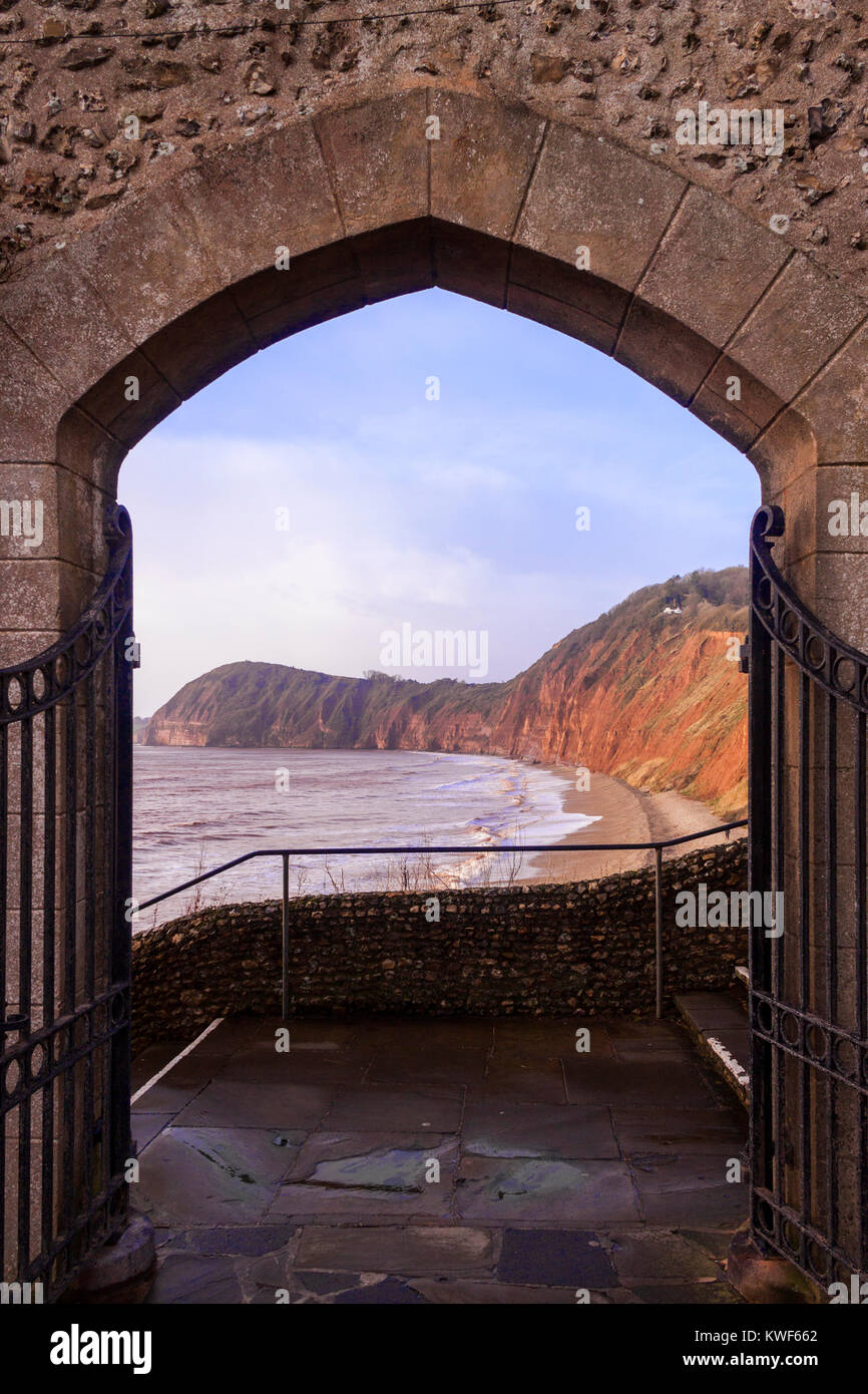 Gates leading out from Connaught Gardens, Sidmouth, with view towards red sandstone cliffs and High Peak Stock Photo