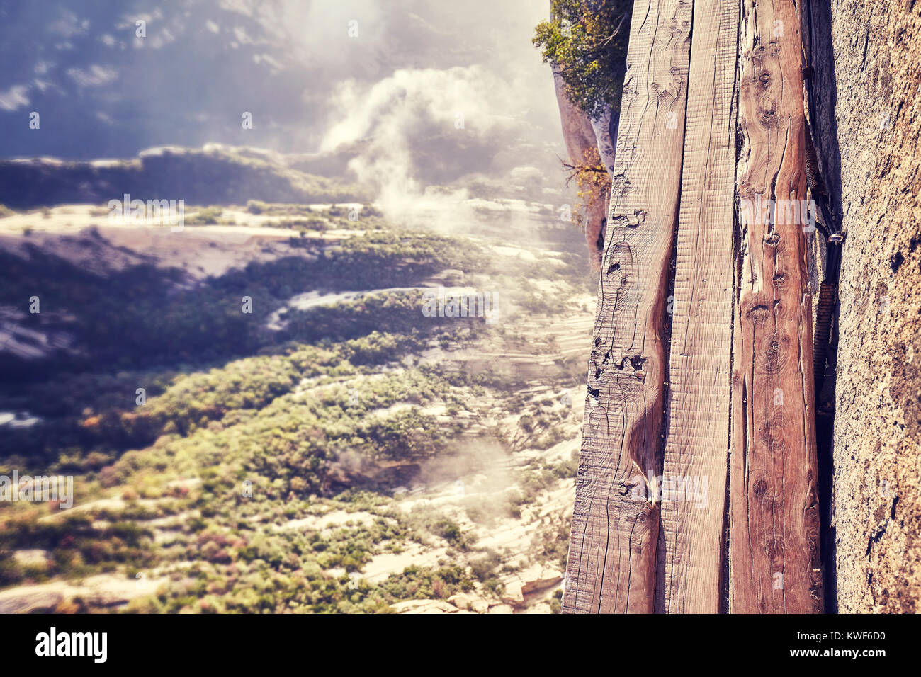 Plank Road at Mount Hua, worlds most dangerous hike, color toned picture, China. Stock Photo