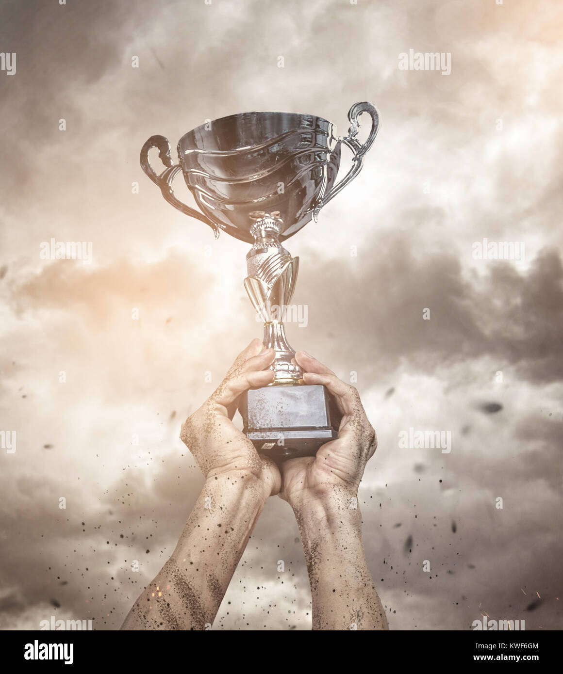 Cropped male arms with winner cup. Stock Photo