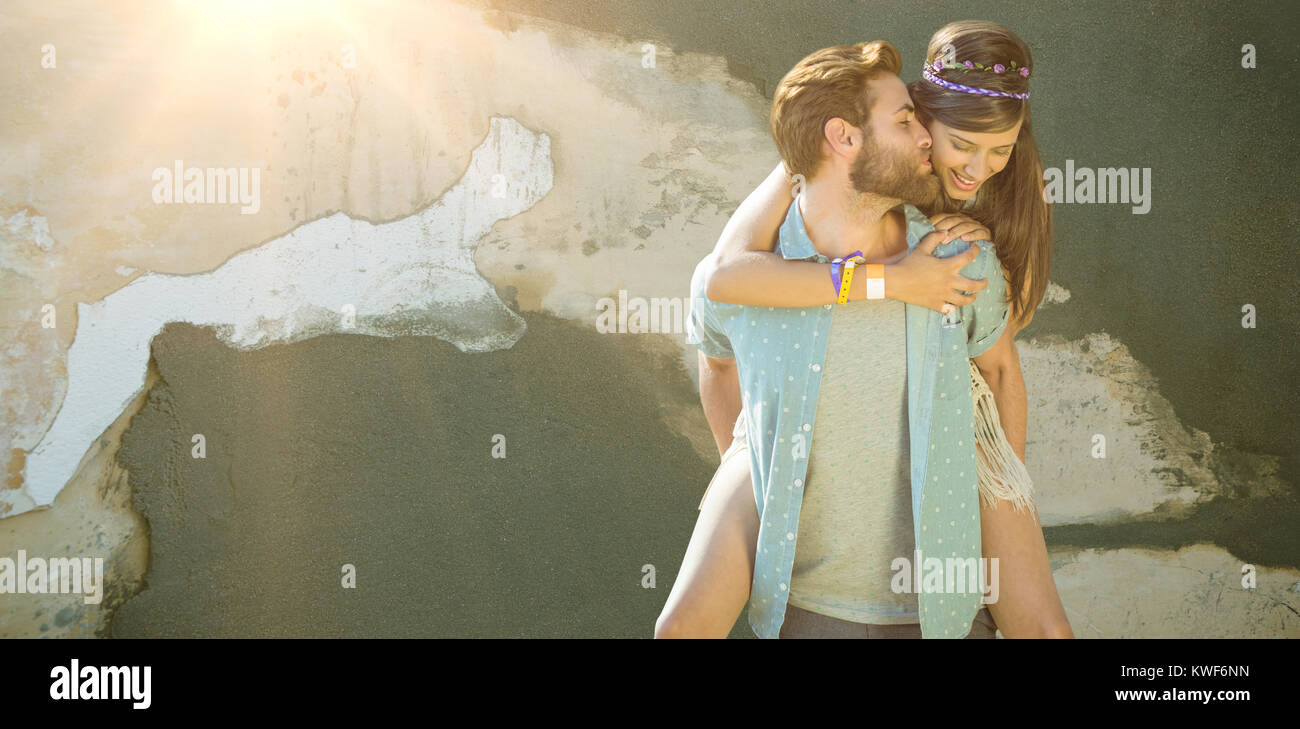 Composite image of man kissing woman while piggybacking Stock Photo
