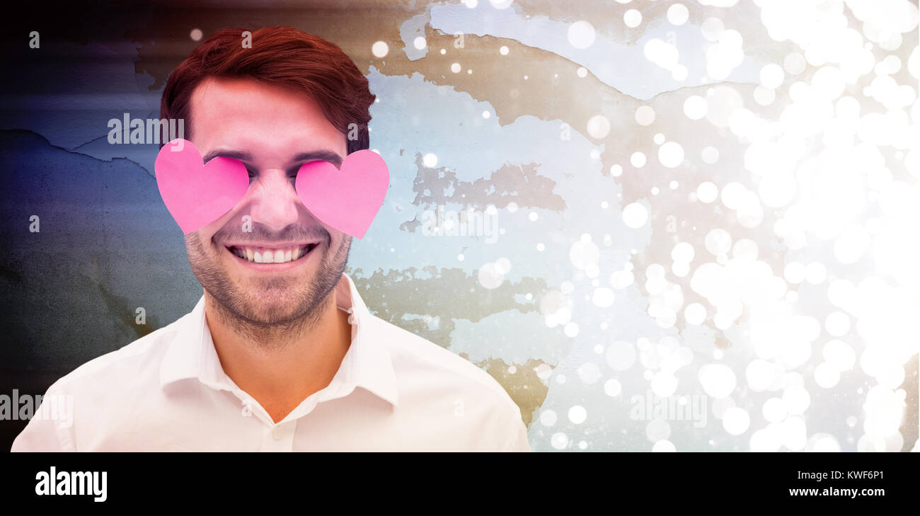 Composite image of handsome man with hearts over his eyes Stock Photo
