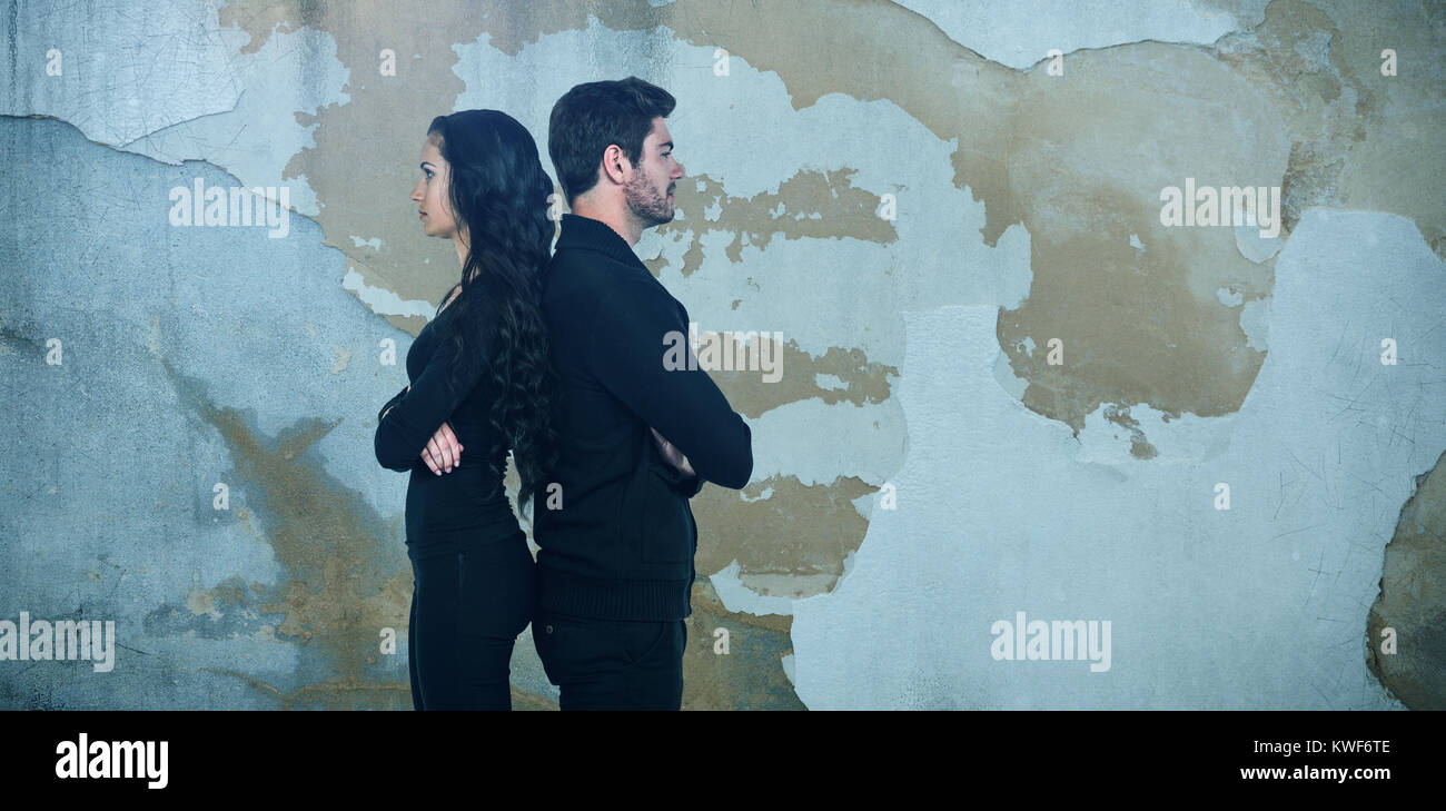 Composite image of profile view of sad couple standing back to back Stock Photo