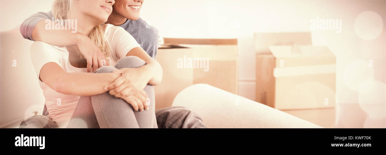 Smiling couple sitting on the floor Stock Photo
