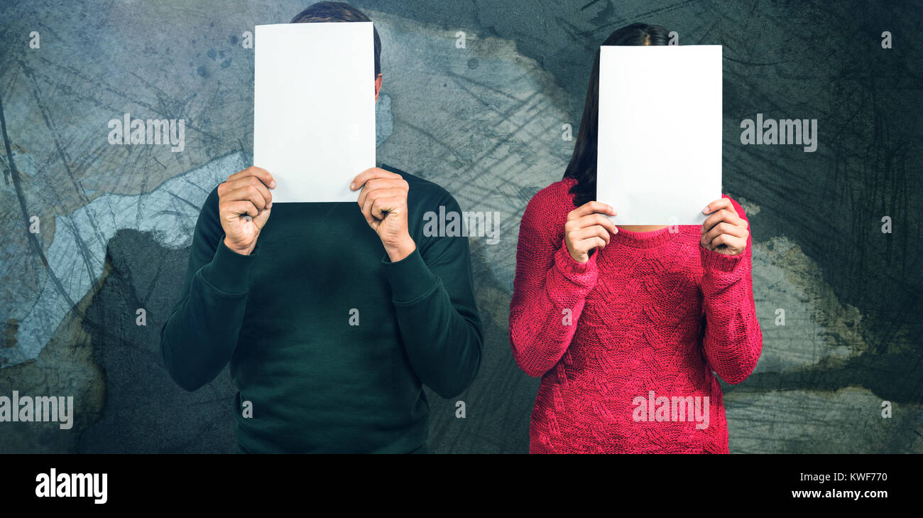 Composite image of couple hiding faces with blank papers Stock Photo